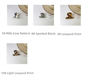 Detailed close-up of acetate mini hair claws in cow, leopard, and spotted patterns