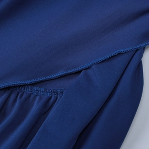 Detailed view of the dark blue dress featuring precise hem stitching and elastic knit fabric