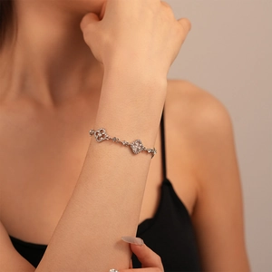 Detail of four-leaf clover bracelet with sparkling micro-pave crystals on the wrist
