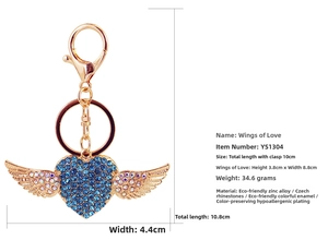 Detail view of heart-shaped angel wings keychain with blue rhinestones and measurements