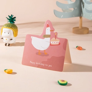 Pink foldable birthday card featuring a cute cartoon duck with a cake and party hat