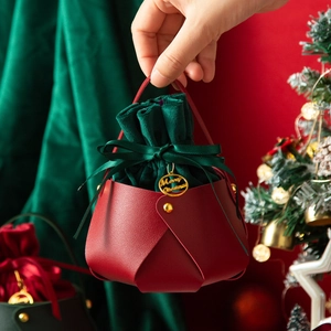 Christmas gift bag with red leather base and green velvet drawstring pouch for apples