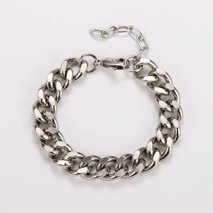 Detail of chunky stainless steel Cuban link bracelet with secure lobster clasp and extension