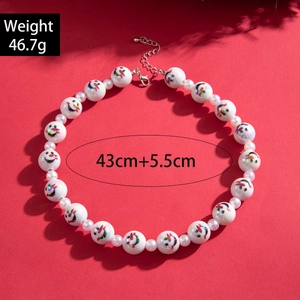 Christmas snowman beaded necklace with faux pearls and silver clasp on red background