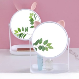 Detail of round tabletop makeup mirror with cute animal ears and jewelry storage base