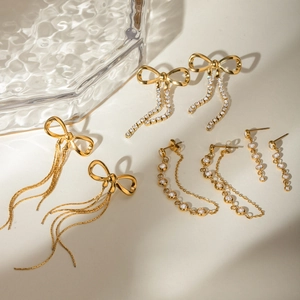 Exquisite gold bow earrings with cascading rhinestone tassels in a luxury jewelry display