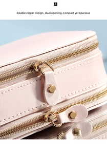 Close-up of pink leather jewelry box featuring dual gold zippers and double-layer storage