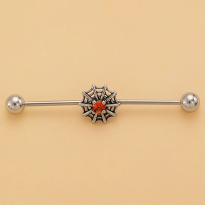 Macro view of stainless steel industrial barbell featuring a spider web with orange gem