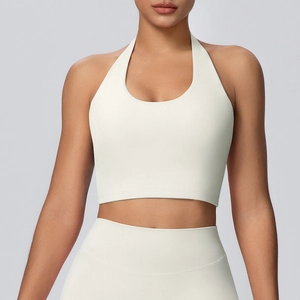 Dettaglio del reggiseno yoga allacciato al collo e leggings coordinati color crema