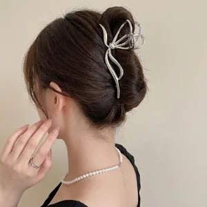 Silver hollow butterfly hair claw clip worn on head for elegant hairstyling
