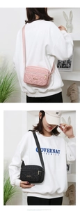 Close-up of quilted heart pattern and JINGPIN metal logo on a nylon crossbody bag