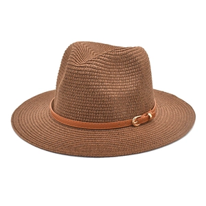 Close-up of brown straw Panama hat with leather band and gold buckle detail