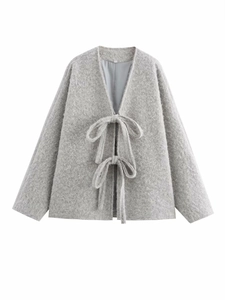 Detail of grey wool-blend cardigan featuring plush texture and elegant bow-tie closure