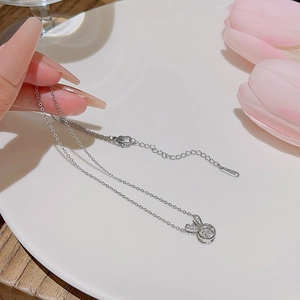 Close-up of S925 sterling silver rabbit pendant with round gemstone on a dainty chain