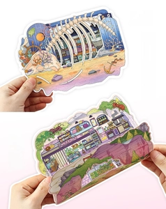 Macro view of detailed layered 3D scenic stickers with beach and house illustrations