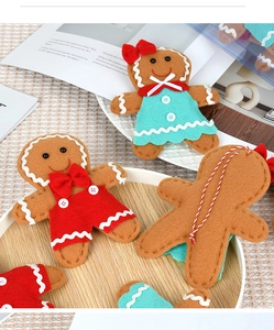 Detail of handmade gingerbread man felt ornaments with hanging ropes for Christmas trees