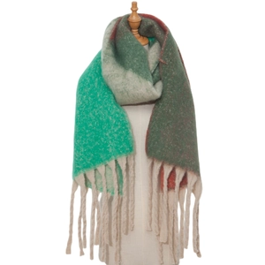 Detailed close-up of thick textured color-block scarf with long beige fringes