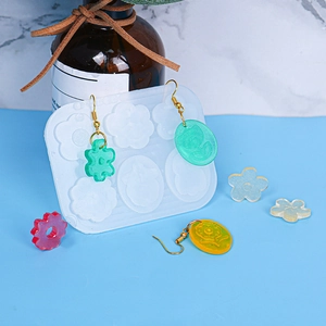 Detalle macro del molde de silicona para pendientes DIY de resina con flores y gatos