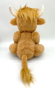 Rear view of long-haired Scottish Highland cow plush toy with soft brown fur and beige horns