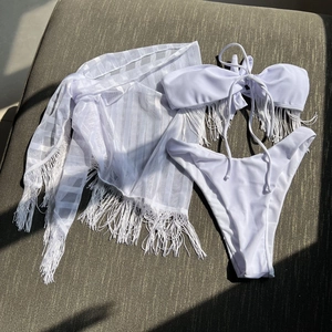 Three-piece white fringe bikini set with mesh cover-up wrap in bohemian resort style