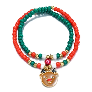 Detail of Christmas beaded bracelet featuring red green beads and a reindeer charm