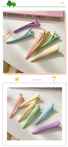 Close-up of matte macaron candy color hair clips arranged on a decorative desk