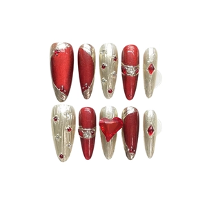 Burgundy and gold press-on nail set with rhinestones and a red heart gem ornament