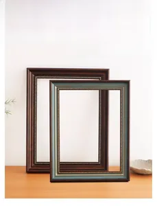 Detail of vintage European solid wood picture frames with golden bead interior decorative trim