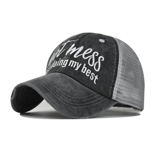 Detail of Hot Mess embroidery on a distressed grey high ponytail mesh baseball cap