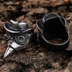Macro shot of punk style plague doctor raven skull ring on textured wood bark background