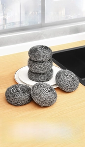Detailed view of six circular stainless steel scouring pads for kitchen cleaning