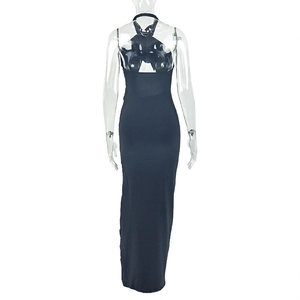 Detail of black halter neck dress showing backless cutout and ruched split hem