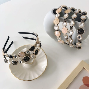 Detailed view of vintage baroque headband with marble beads and crystals on shell plate