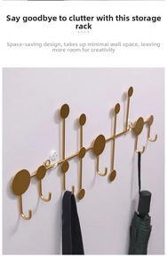 Detail of matte gold wall-mounted coat rack with geometric metal hooks for home storage