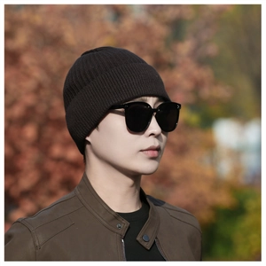Detail of men's thick knit beanie with fine ribbed texture and folded edge design