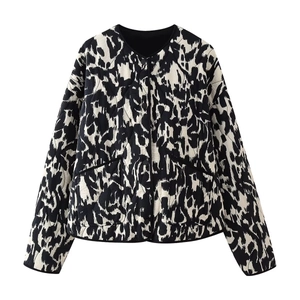 Close-up of quilted pattern and button details on a black and white leopard print jacket