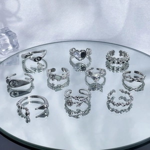 Set of 10 silver irregular open rings featuring snake, heart, and chain designs on mirror