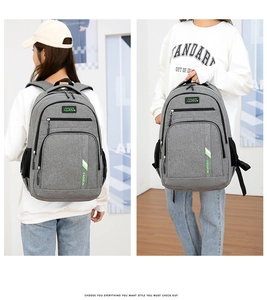 Gray business laptop backpack featuring wide shoulder straps and side pockets detail