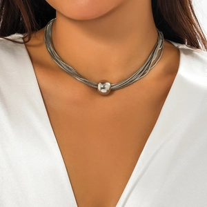 Close-up of a silver multilayer chain necklace with a large round bead ball pendant