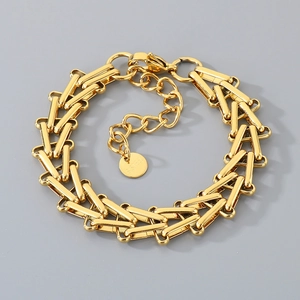 Detail of gold woven horseshoe chain bracelet with S.STEEL material engraving mark