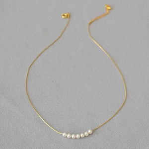 Elegant gold plated necklace with seven round pearls and minimalist thin cable chain