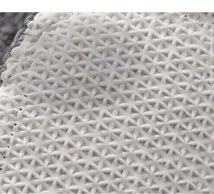 Detail of light grey TPR bathroom mat bottom with non-slip star-shaped safety texture