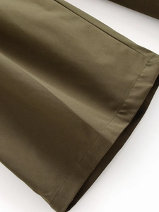 Detail of olive green high-waisted wide-leg pants showing premium cotton twill texture