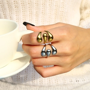 Detailed view of silver and 18K gold plated stainless steel lava rings on fingers