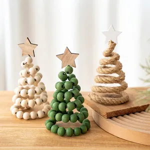 Three minimalist wooden spiral Christmas trees with star toppers on a cozy tabletop