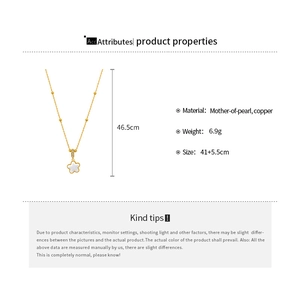 Detailed view of gold star pendant necklace made with mother of pearl and copper