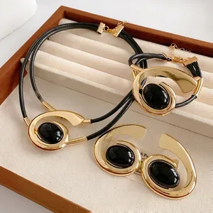 Retro black and gold jewelry set featuring necklace, bracelet, and studs in a gift box