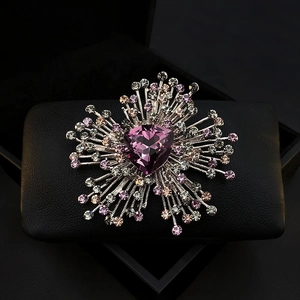 Luxury heart-shaped purple crystal brooch with silver accents on a black base