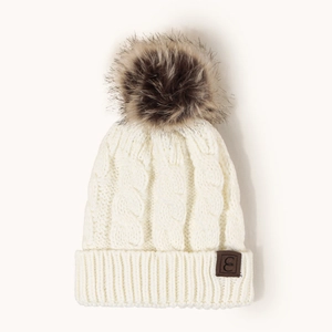 Unisex cream cable knit beanie with oversized faux fur pom and leather logo patch