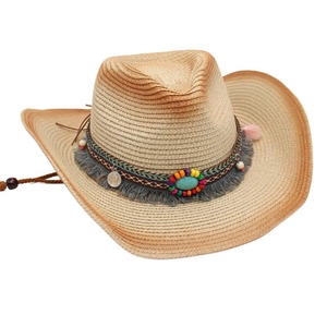 Close-up of woven cowboy straw hat with colorful beads, tassels and vintage coin detail